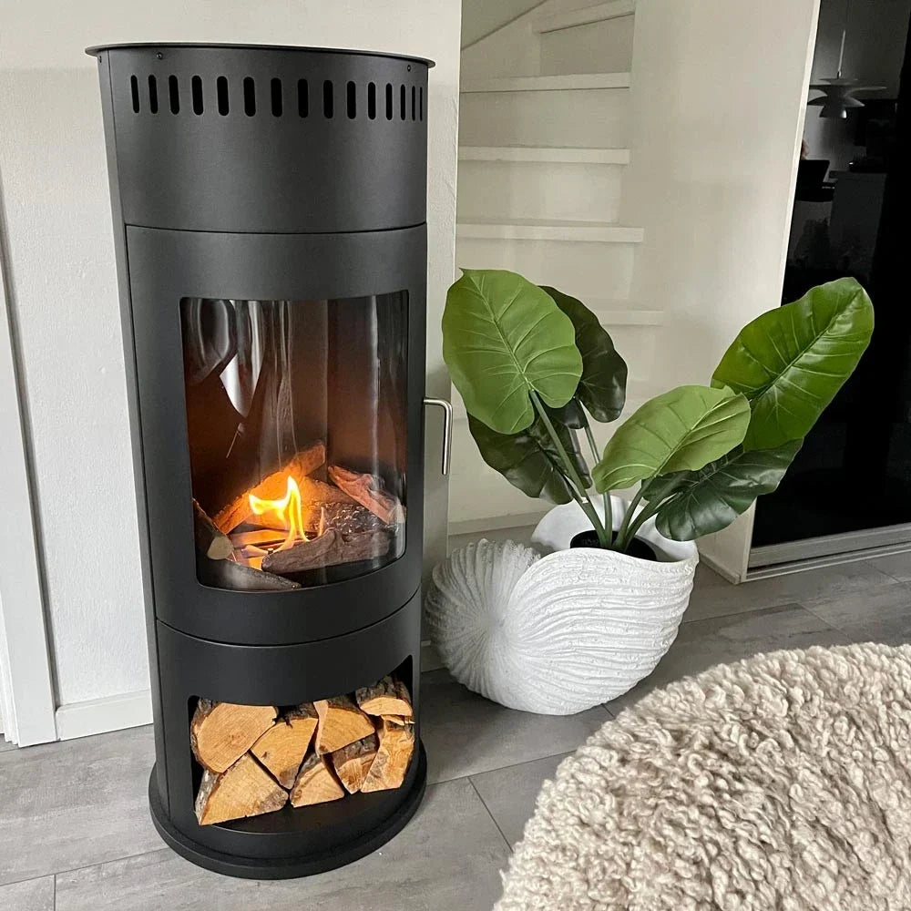Washington black bioethanol stove lit in a real home beside a plant and staircase